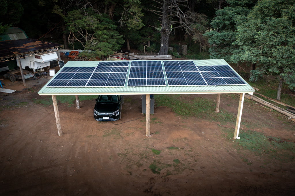A metal roofed carport with mounted solar panels